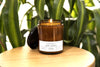 Herb Garden candle illuminating a cozy space, surrounded by lush green plants and showcasing its fresh, vibrant fragrance.